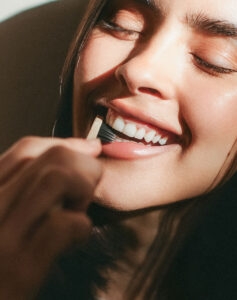 smiling with toothbrush at russo dds raleigh nc clean teeth detnal exams and cleanings