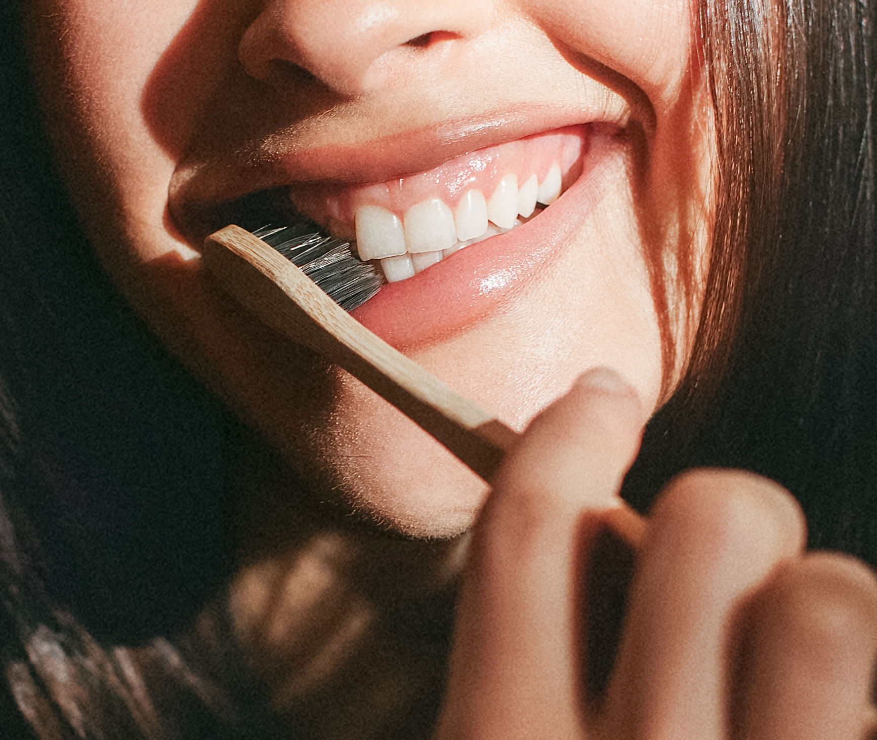 smiling with toothbrush at russo dds raleigh nc clean teeth detnal exams and cleanings history of teeth brushing